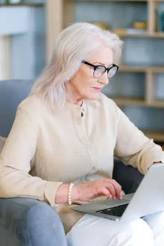 An elderly lady researching what services Medicare will cover.