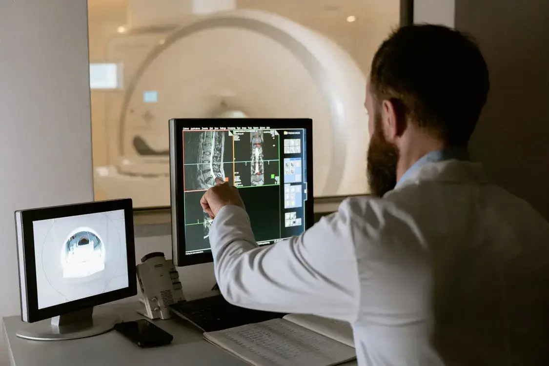 A doctor that is examining an X-Ray.