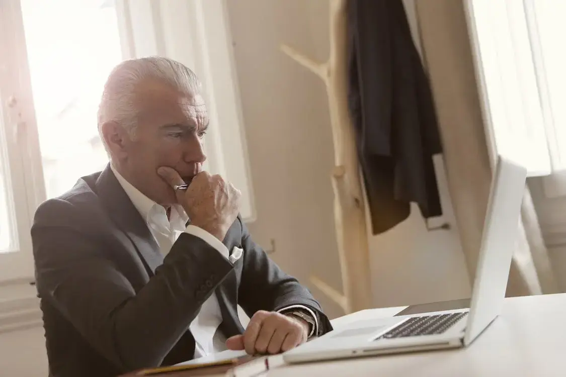 A Medicare beneficiary looking at his different coverage options before calling his insurance agent.