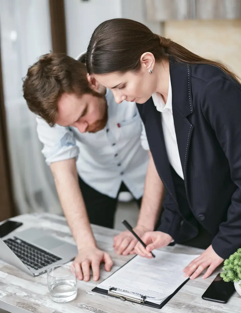 A man and woman signing up for Voluntary Life Insurance.