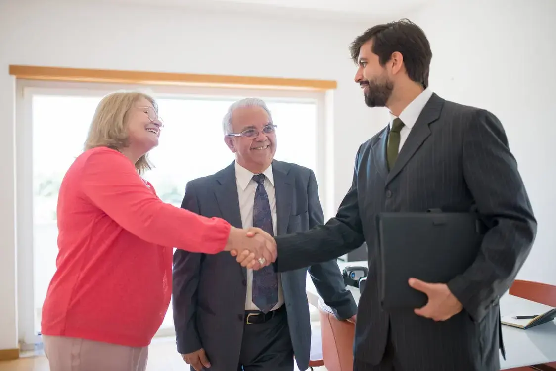 An older couple greeting their Medicare insurance agent.