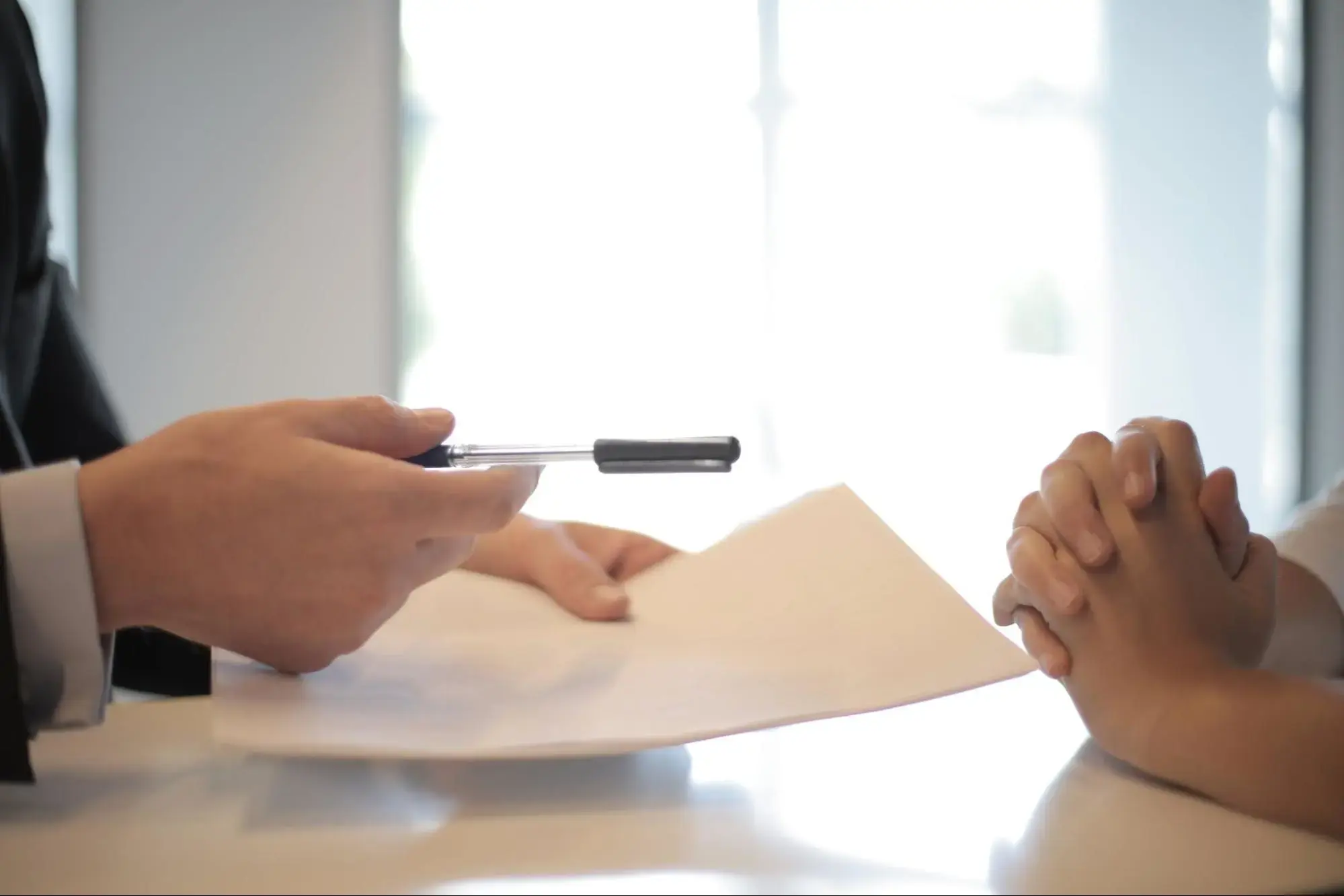 A person signing up for Life Insurance with their insurance agent.