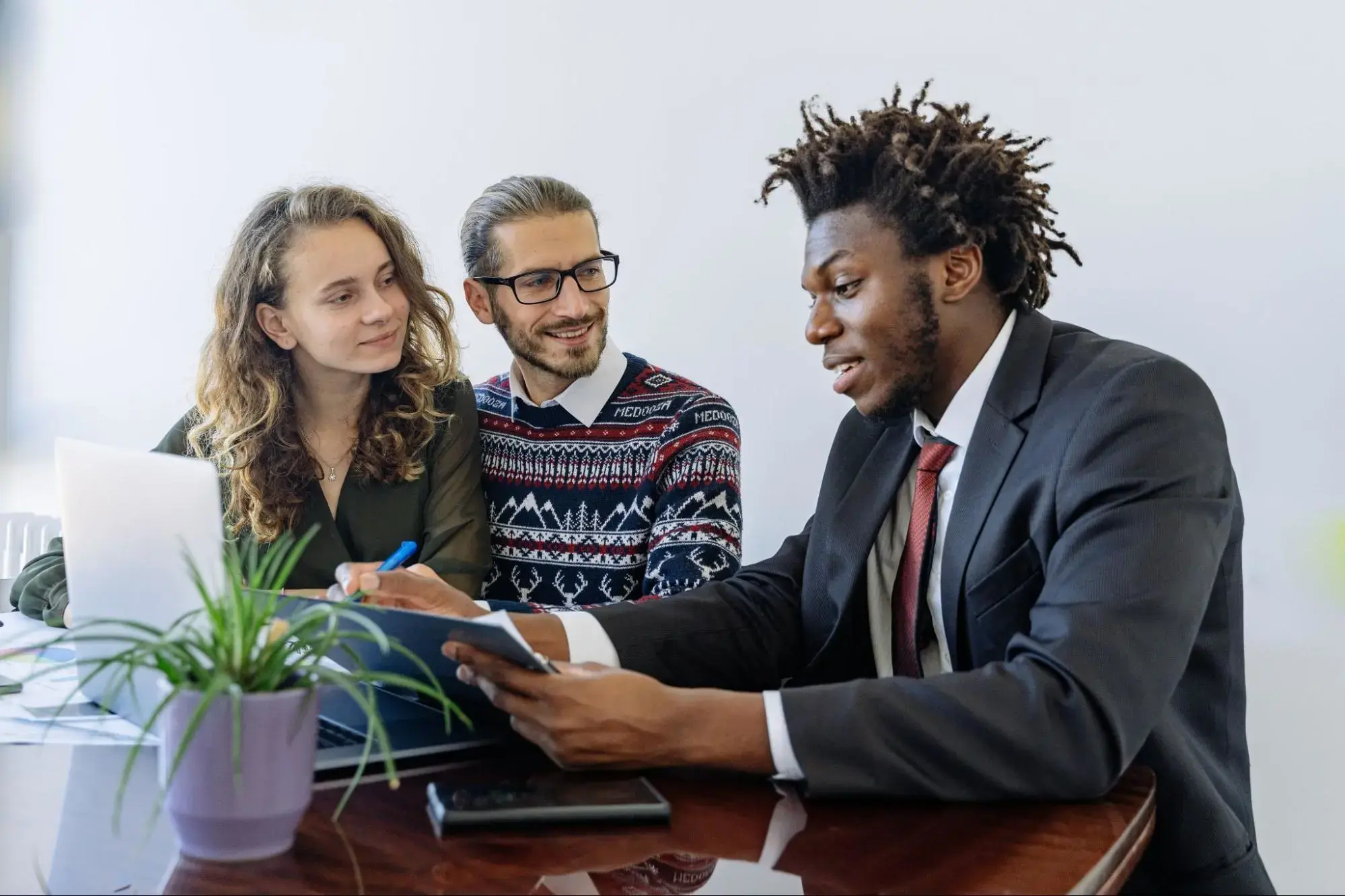 A life insurance consultant teaching a young couple about credit term life insurance.