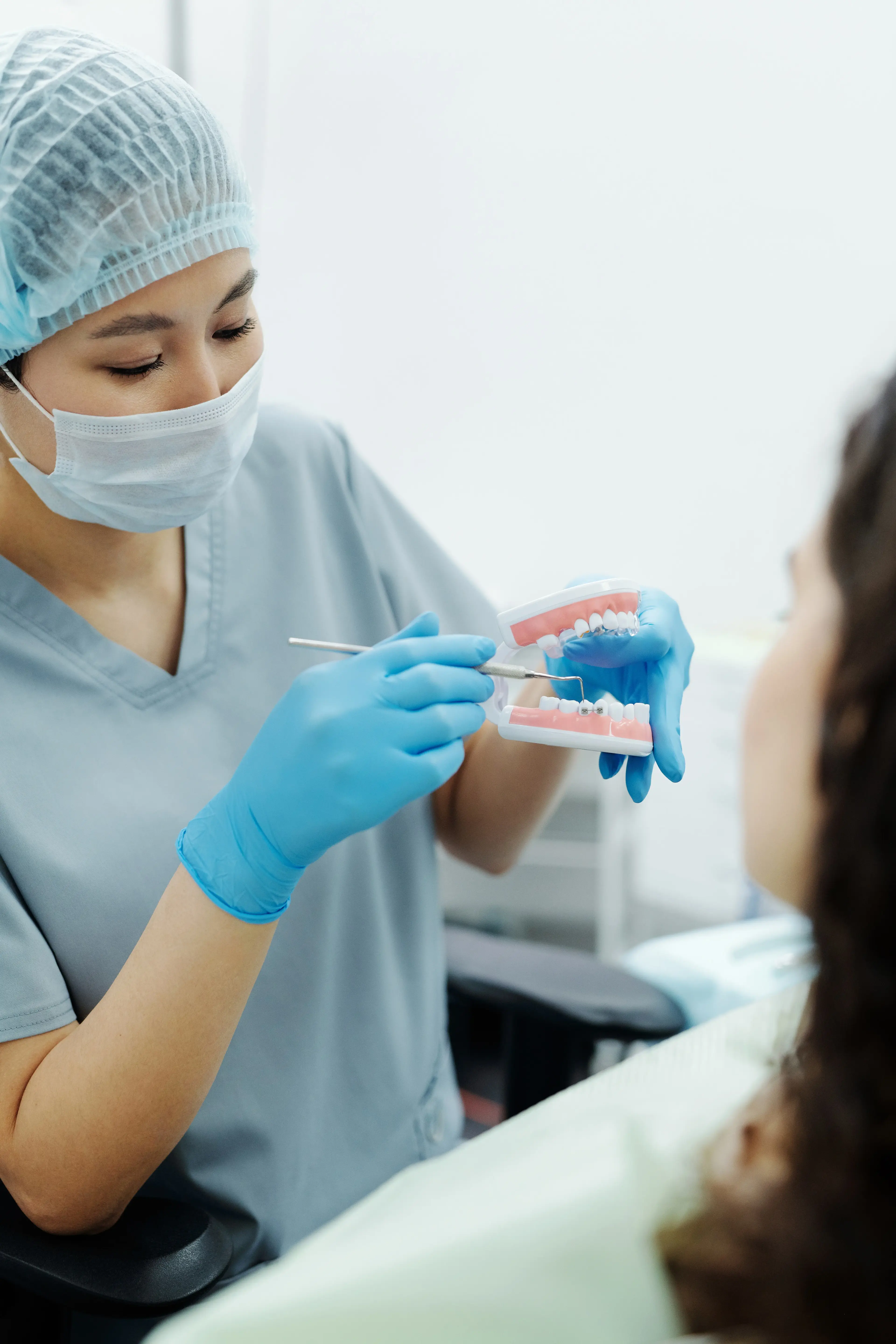 A dentist preparing dentures for a patient covered by Medicare.